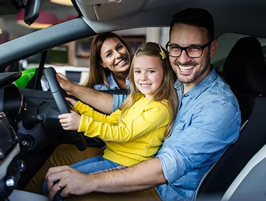 Family of three sitting in car happy with getting specialist car finance